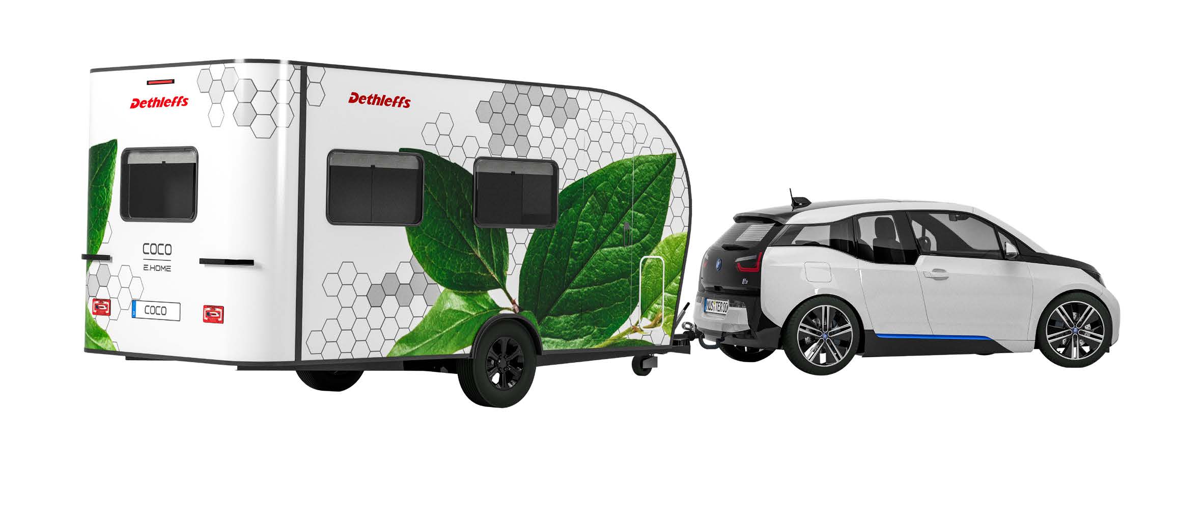 frilagd bild på bil med husvagn. Husvagnen är dekorerad med stora gröna påmålade blad mot vit botten.